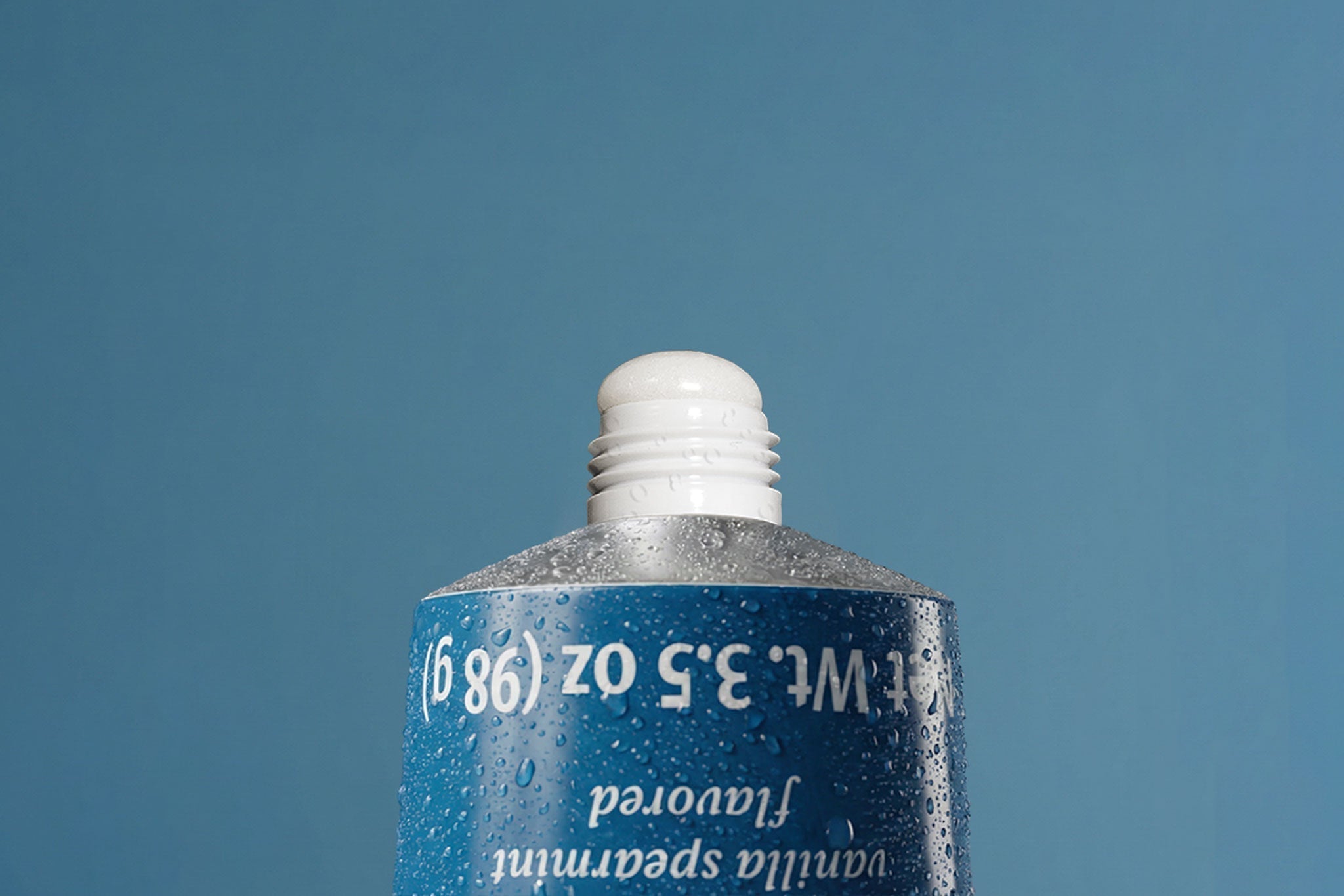 Close-up of Akla hydroxyapatite toothpaste tube showing pure nano-hydroxyapatite paste at the opening.