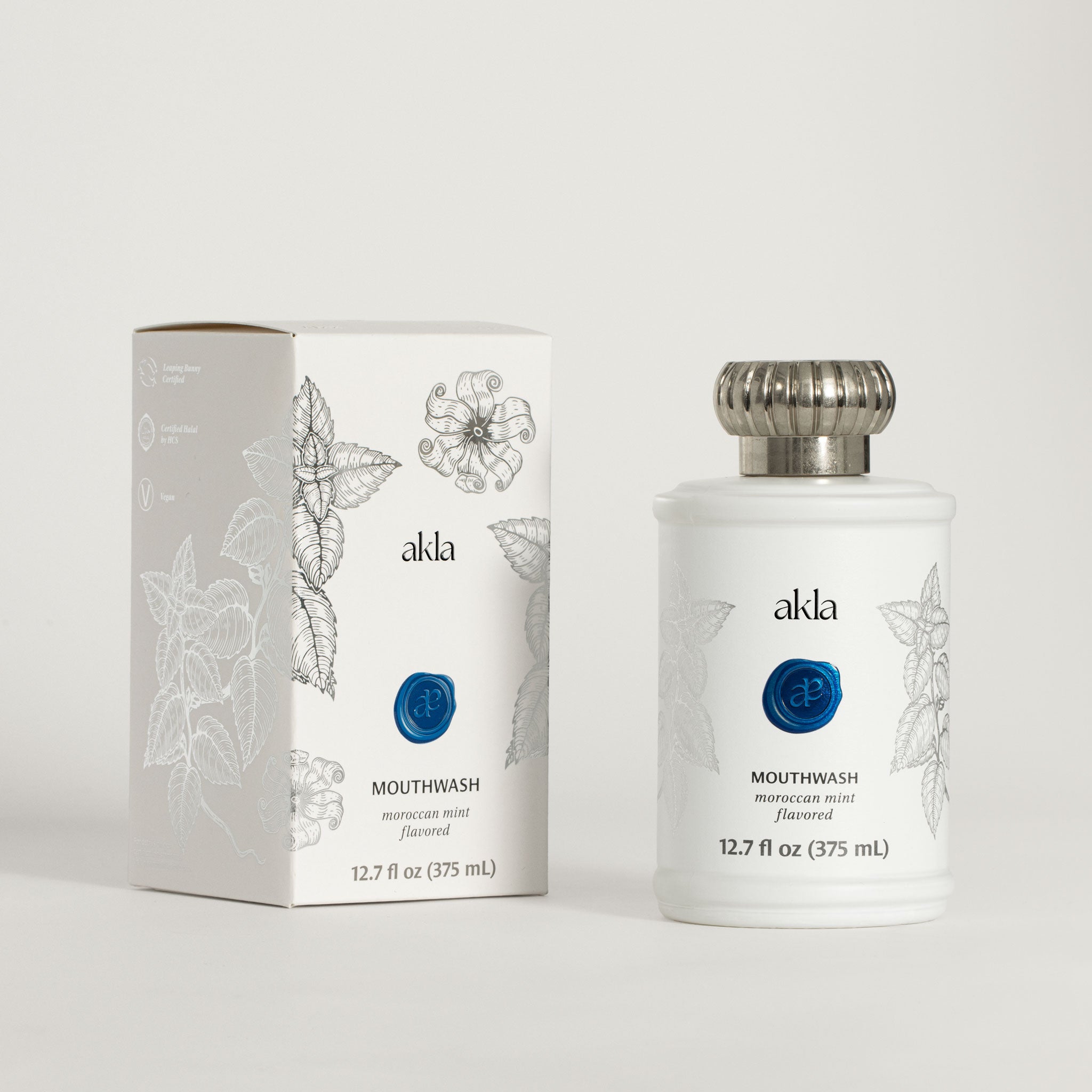 Akla alcohol free mouthwash white glass bottle and box packaging.