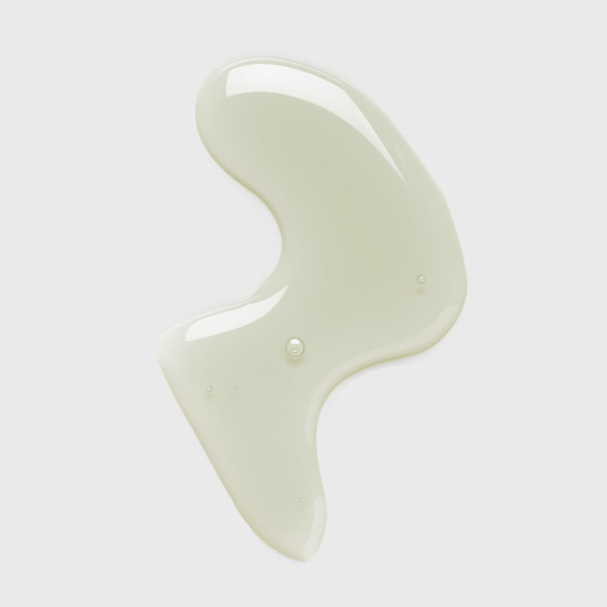 Light green spearmint oil ingredient smear on light grey background.