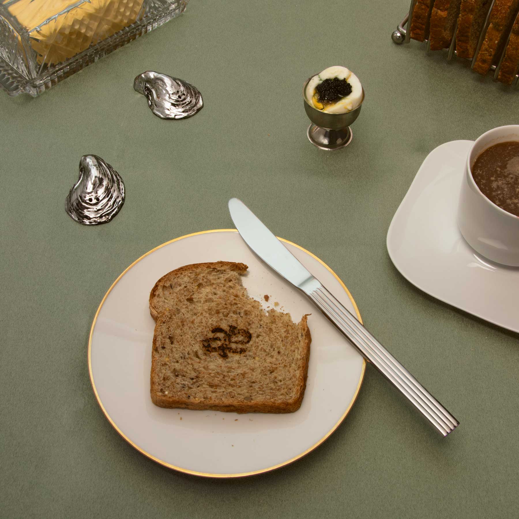 Luxury oral care breakfast scene featuring Akla fluoride-free toothpaste beside toast, coffee, and morning light. A ritual of intention and elegance.