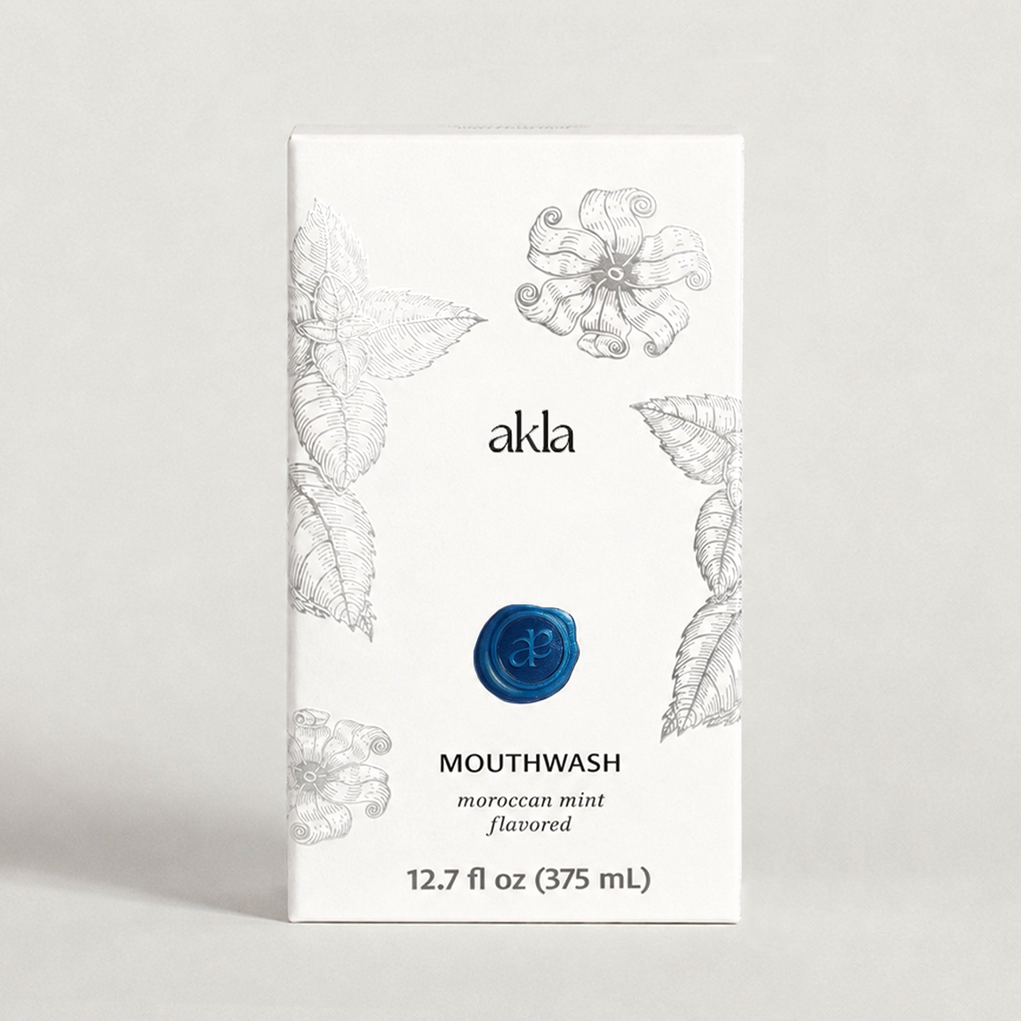 Akla Moroccan Mint Mouthwash carton packaging with botanical silver illustrations. Alcohol-free Swiss-made oral care.