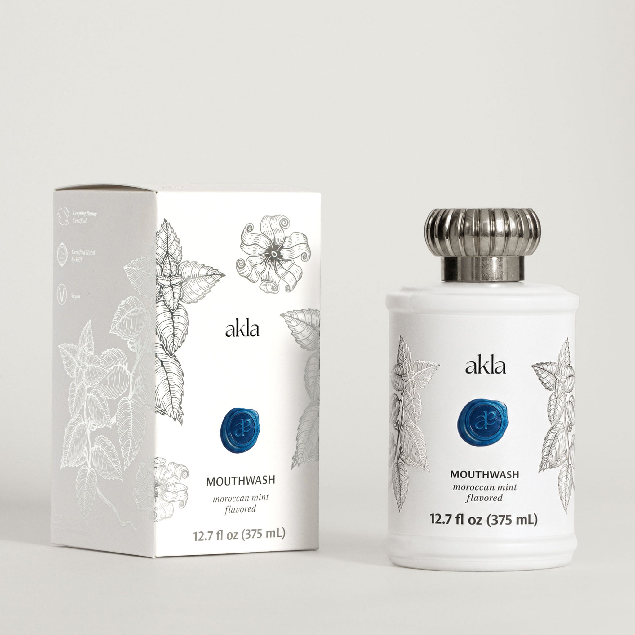 Akla Moroccan Mint Mouthwash bottle and carton shown at three-quarter angle. Swiss-made luxury oral care packaging.