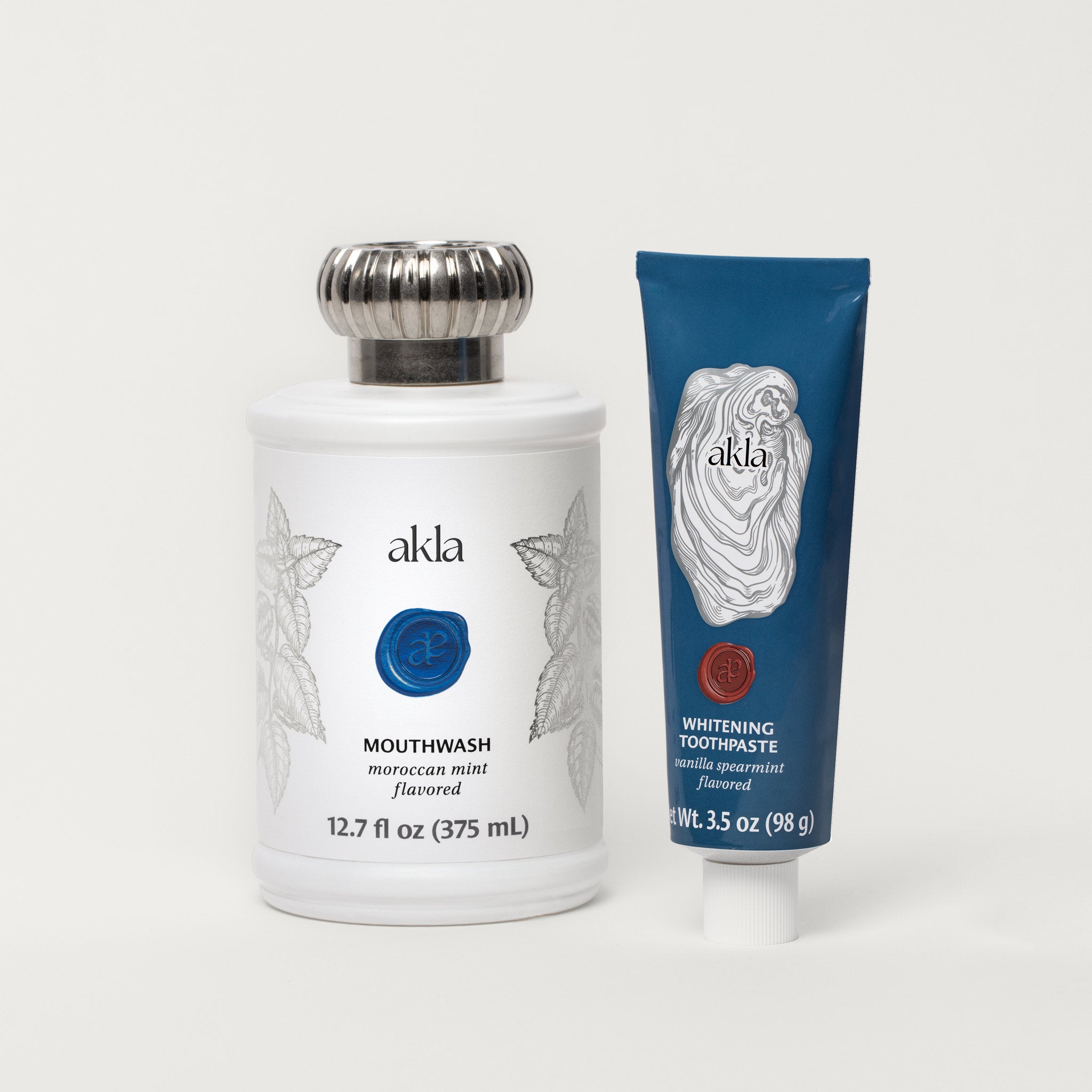 Akla oral care duo – fluoride-free Moroccan Mint Mouthwash and Vanilla Spearmint Whitening Toothpaste in design-forward, recyclable packaging.