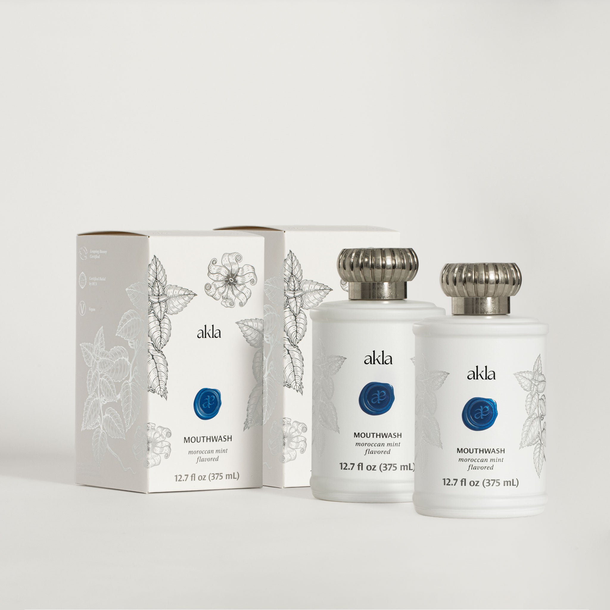 Akla Mouthwash Duo — two glass bottles and boxes of Moroccan Mint fluoride-free oral rinse, Swiss-made luxury mouthwash.