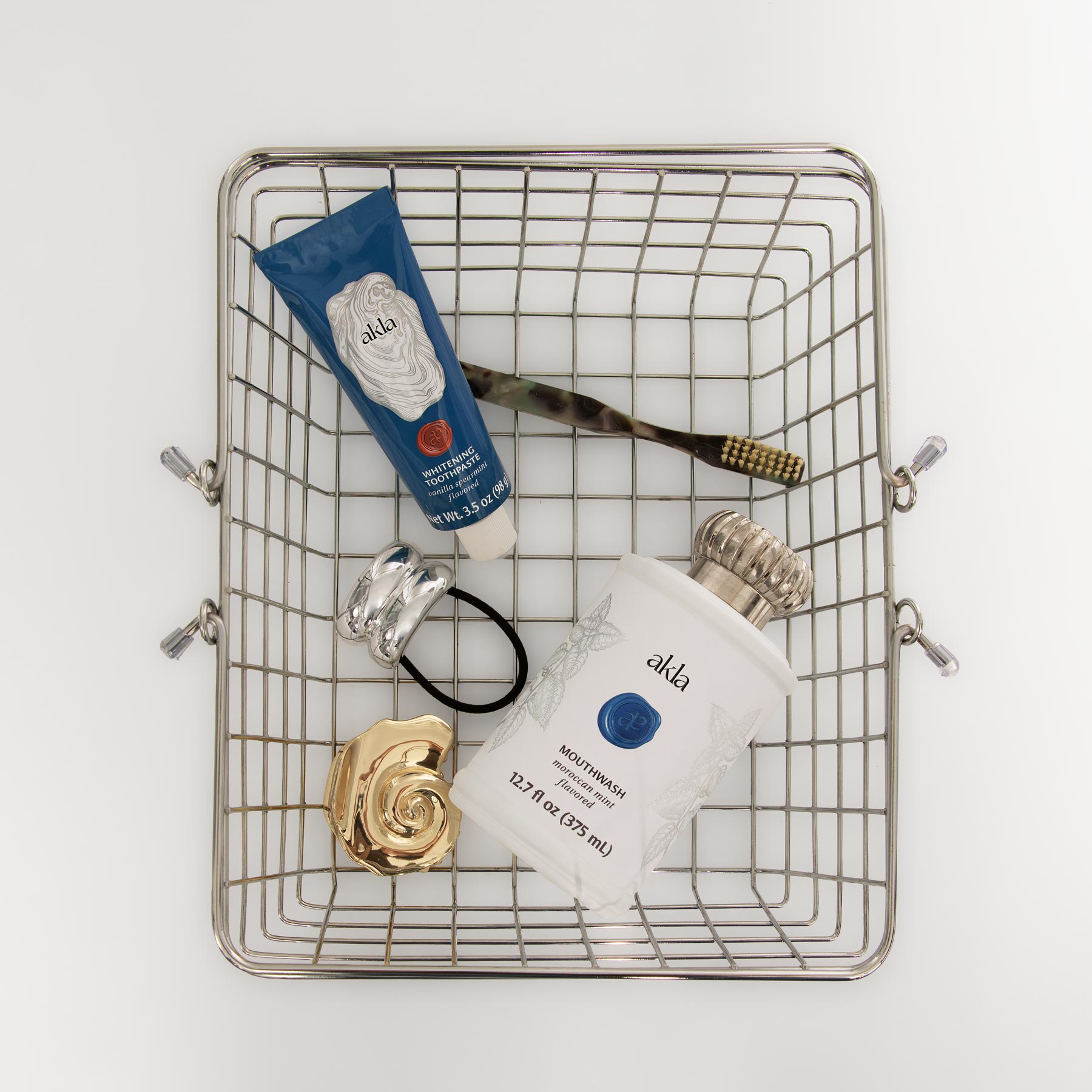 Shopping cart with luxury personal care products including Akla's fluoride-free toothpaste and mouthwash.