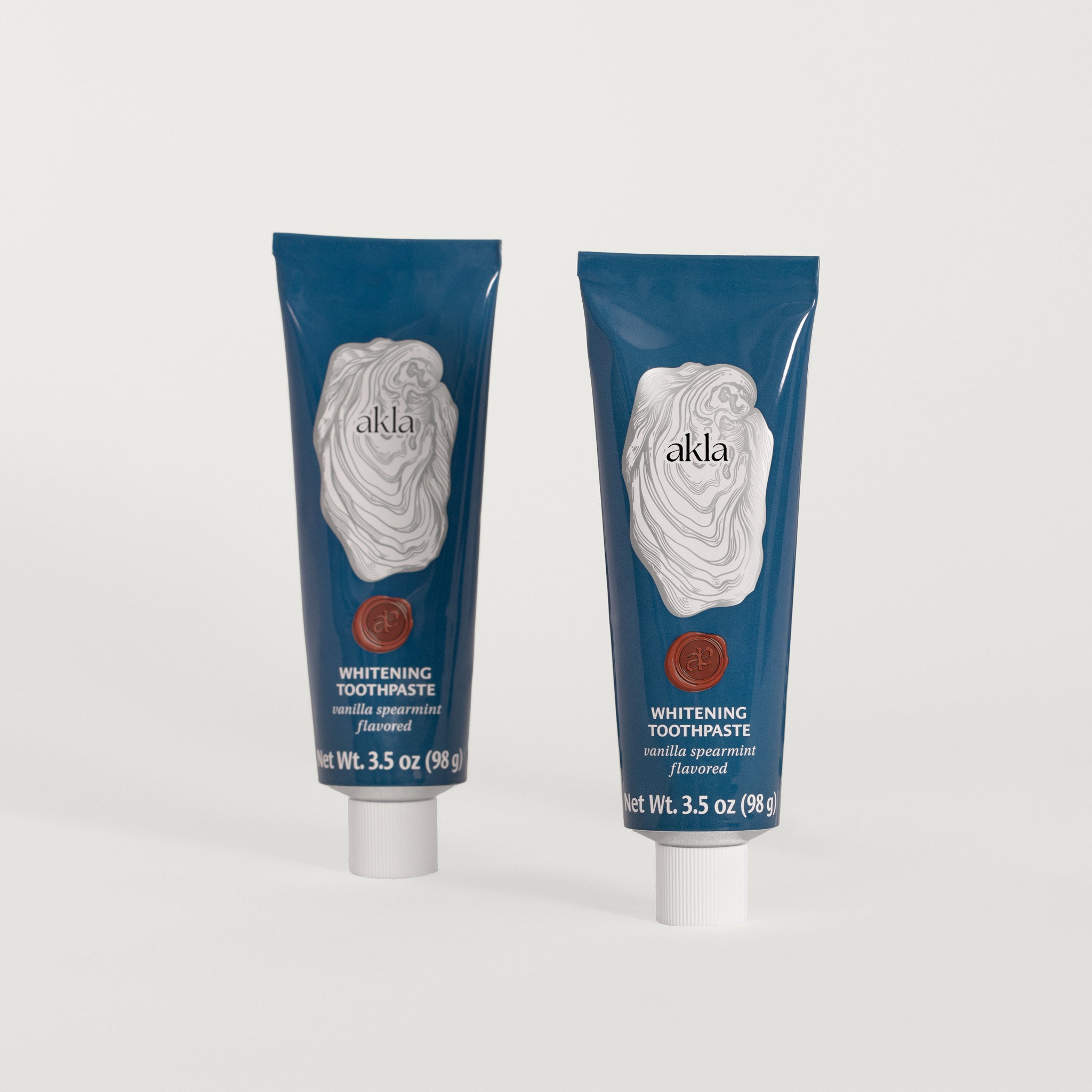 Two tubes of Akla Vanilla Spearmint Whitening Toothpaste – fluoride-free and enriched with nano-hydroxyapatite in recyclable aluminum packaging.