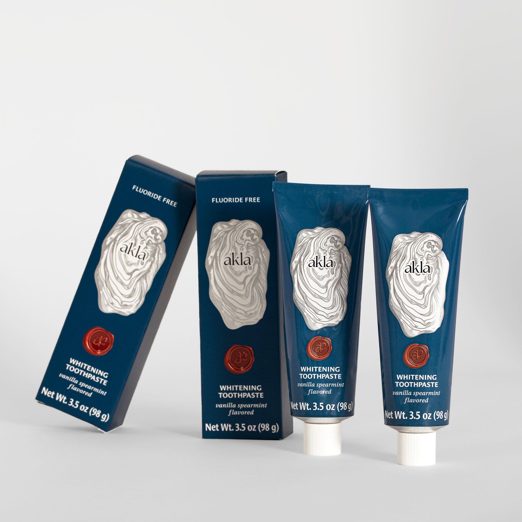 Akla Whitening Toothpaste with Vanilla Spearmint Flavor – two tubes and boxes displayed together.