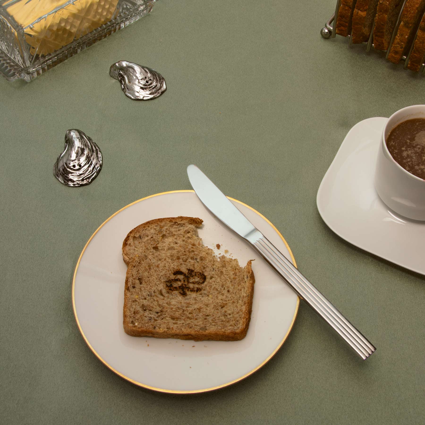 Luxury oral care breakfast scene featuring Akla fluoride-free toothpaste beside toast, coffee, and morning light. A ritual of intention and elegance.