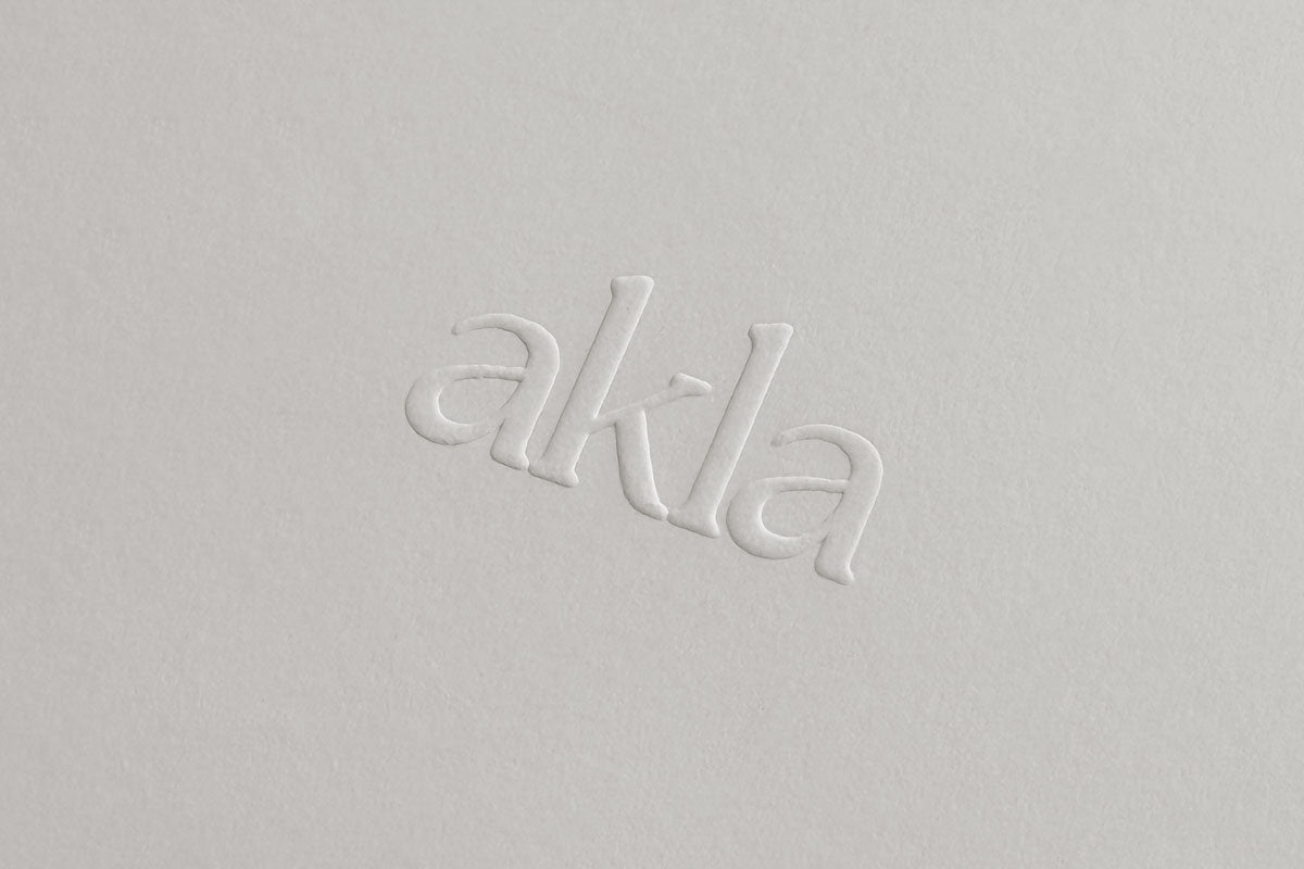 Close-up of Akla logo blind embossed on packaging, reflecting understated luxury and tactile refinement in modern oral care.