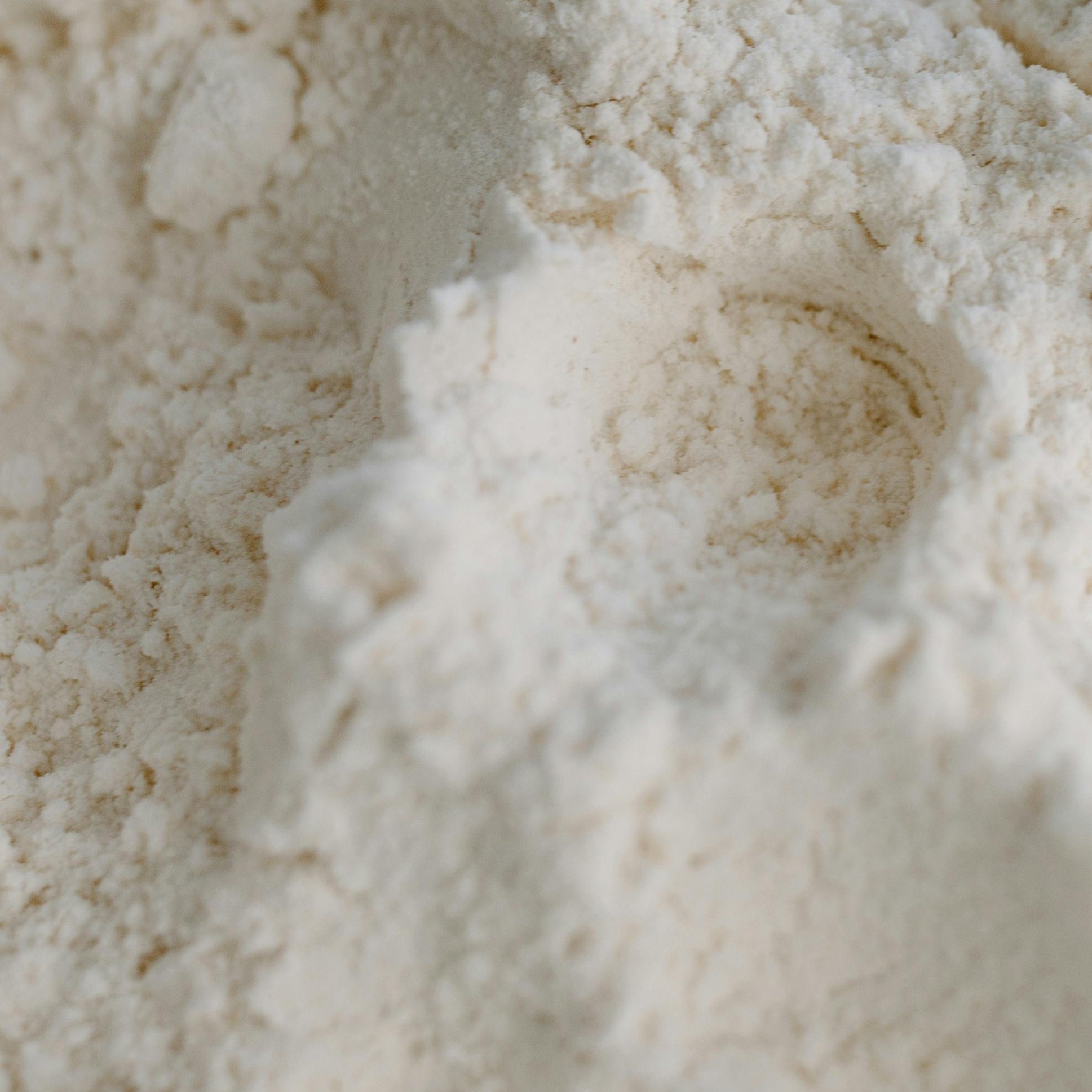 Pure hydroxyapatite powder texture representing clean ingredients in Akla’s premium fluoride-free toothpaste.