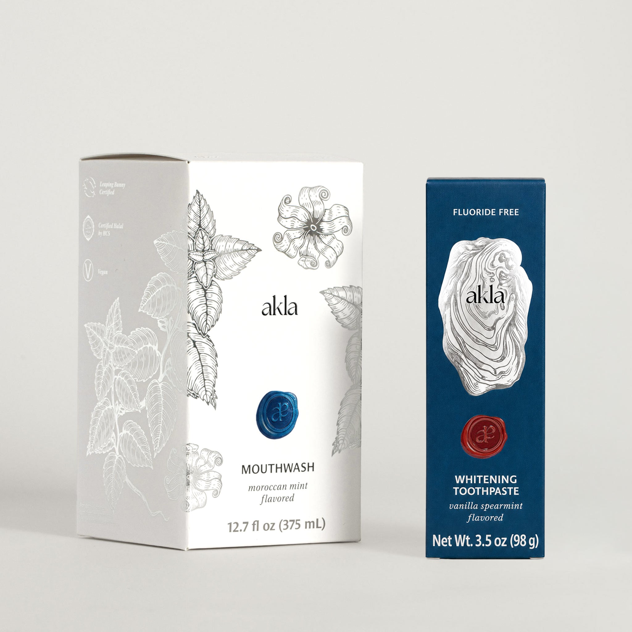 Akla Essentials Set packaging with toothpaste and mouthwash cartons. Luxury Swiss-made oral care.
