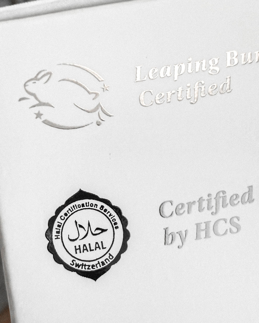 Close-up of Akla mouthwash box with Leaping Bunny and Halal certification icons printed on the packaging.