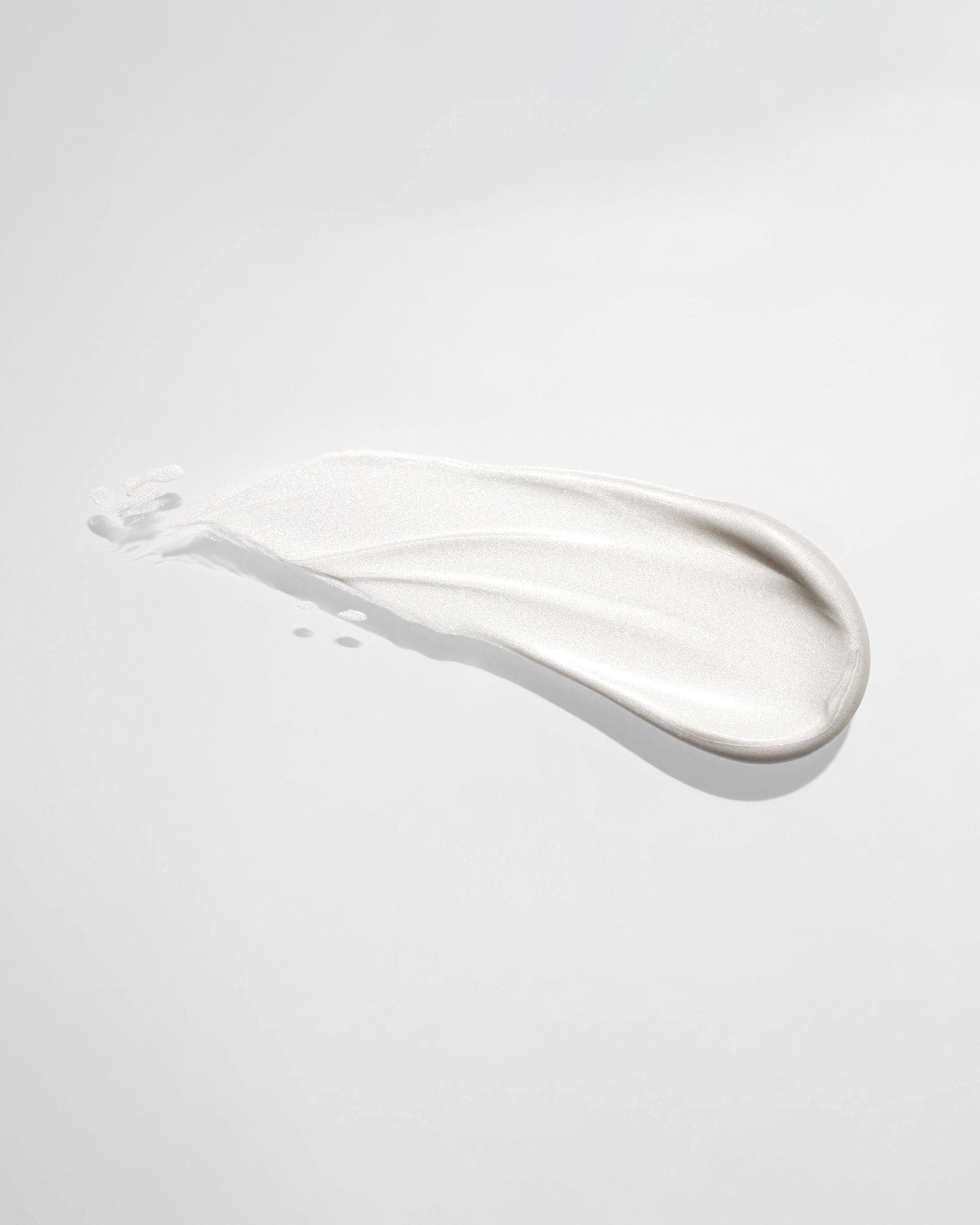 Toothpaste smear on light background.